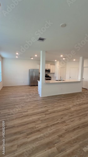 Empty House Interior Open Concept Living Room and Kitchen with Wood Flooring.  