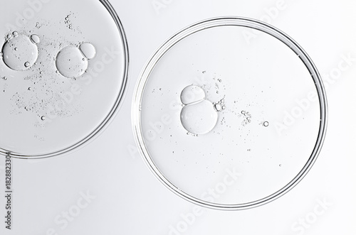 The texture of a cosmetic serum or body gel in a Petri dish.