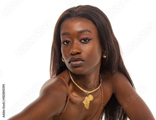 Portrait of an elegant young woman with gold Africa pendant