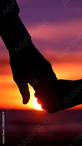 Couple holding hands silhouette at sunset, romantic love relationship, trust and support concept, vertical 9:16 background for social media stories
