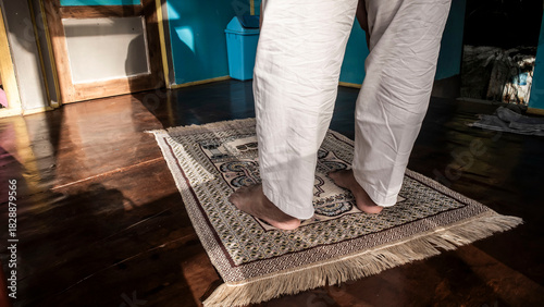 a Muslim praying with prayer mat