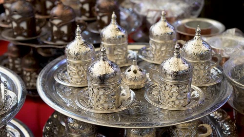 Close up view of traditional turkish coffee pots, tea sets, ceramic pots in a shop.