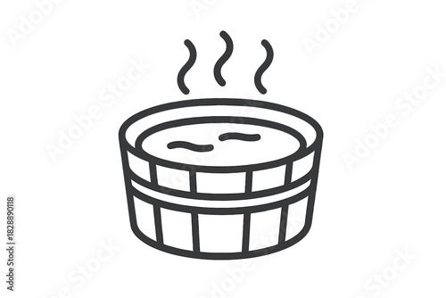 Traditional wooden hot tub filled with steaming water used for relaxation and spa therapy