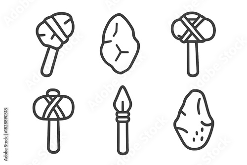 Collection of prehistoric Stone Age tools and primitive weapons including hand axes, stone hammers, and a spearhead