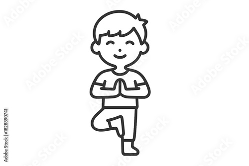 Happy young boy practicing yoga in tree pose standing on one leg with hands in prayer position