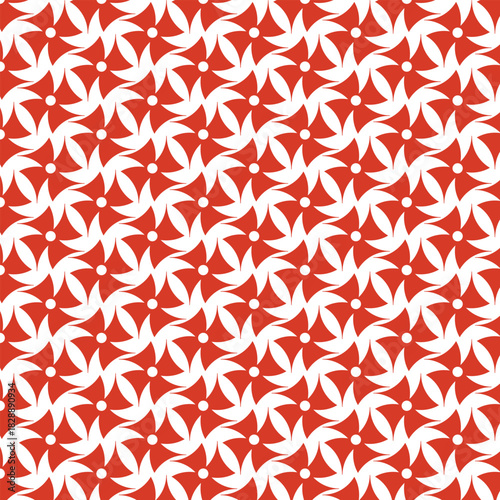 Intricate geometric pattern of repeating red and white pinwheel motifs creating a visually dynamic and complex textile design
