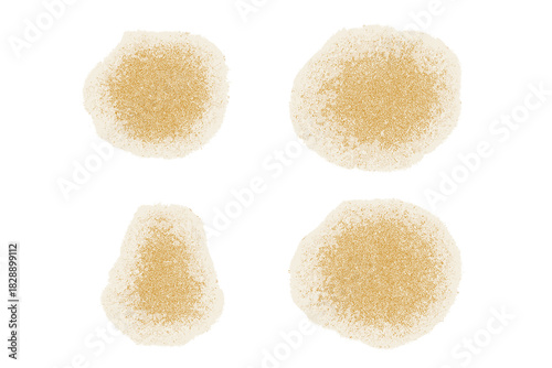 Four abstract textured yellow stains or powder piles isolated on white background