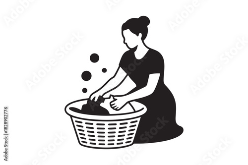 Woman washing clothes by hand in a basket with bubbles