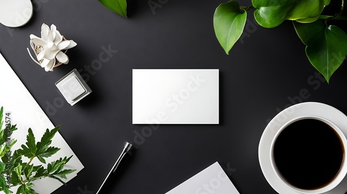 Blank business card mockup on black desk with coffee and plants for branding and design display