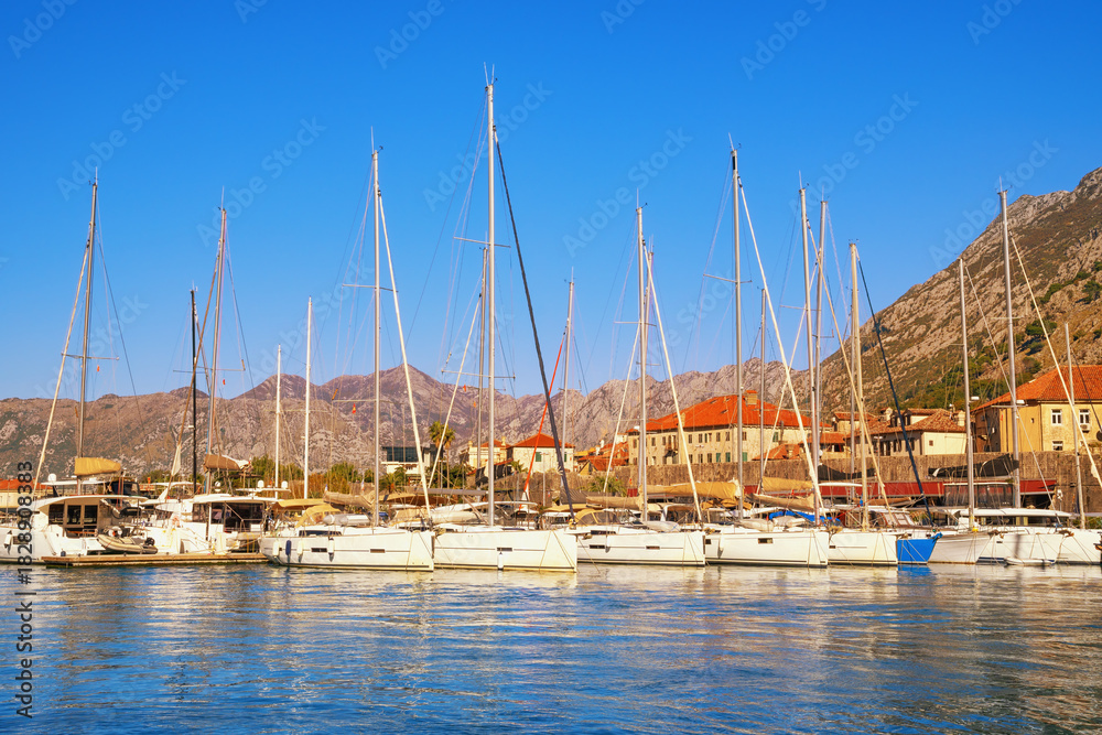 Obraz premium Sailboats in port near Kotor Old Town on sunny autumn day. Bay of Kotor, Montenegro