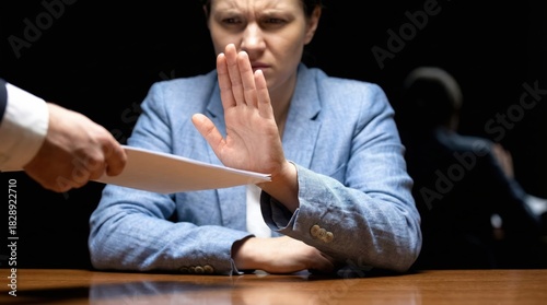 Woman refusing document with gesture in a tense close up
