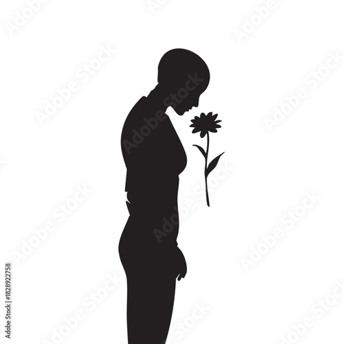 Silhouette of a person with short hair smelling a single flower
