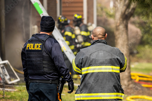 Policemen with Firefighter from the back managing firefighters work