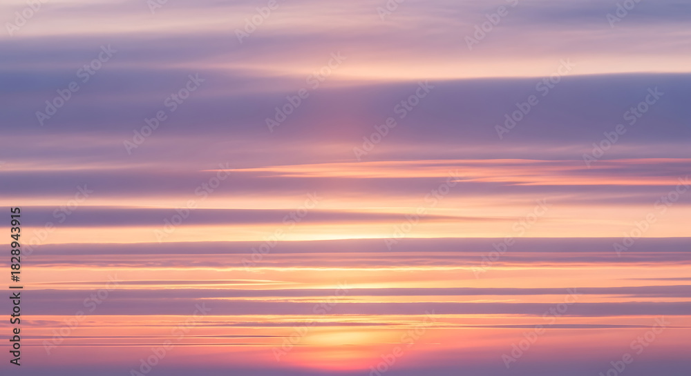 Obraz premium Vibrant Sunset Sky with Pastel Shades and Subtle Cloud Layers Creating Peaceful and Tranquil Atmospheric Outdoor Scenery in Beautiful Nature