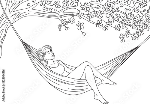 Woman in hammock relaxing under a blossoming tree