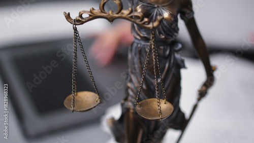 Фотография Bronze statue of Lady Justice holding scales, symbolizing fairness and law, with