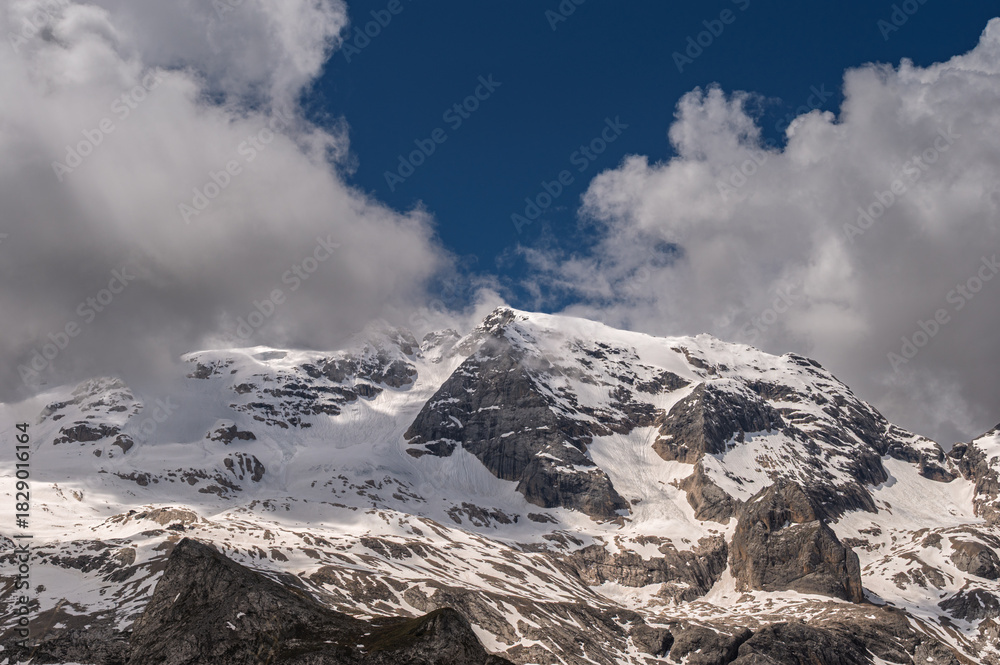 Obraz premium Marmolada mountain range seen from the viel del pan trail during a summer cloudy day, Canazei, Dolomites, Italy