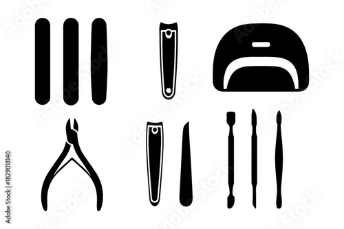 Black and white manicure tools set with nail clippers and uv lamp.