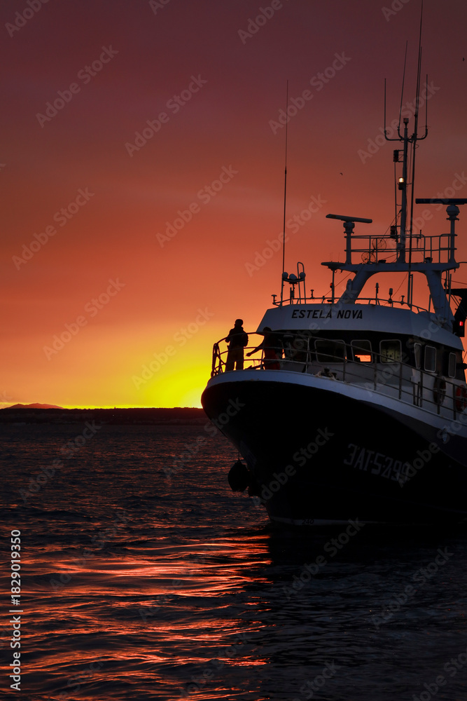 Fototapeta premium Fishing Boat returning to the Port of Santa Pola at sunset