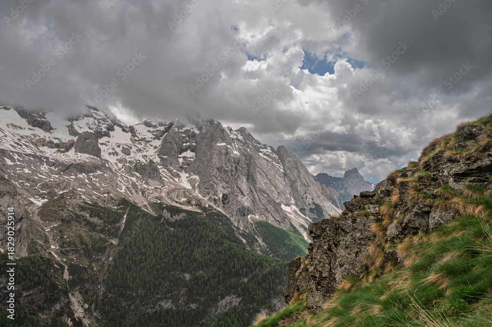 Obraz premium Marmolada mountain range seen from the viel del pan trail during a summer cloudy day, Canazei, Dolomites, Italy