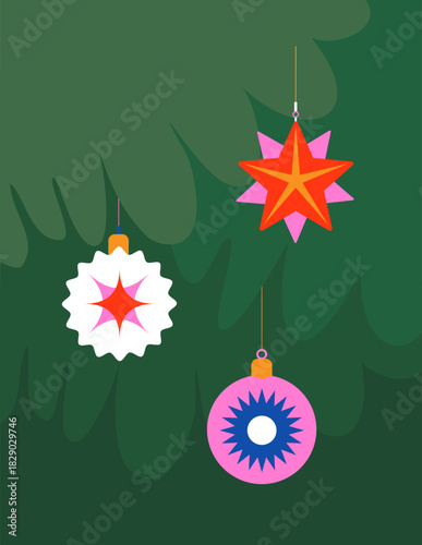 Christmas toys on a green Christmas tree background. New Year or Christmas card and minimalism style.