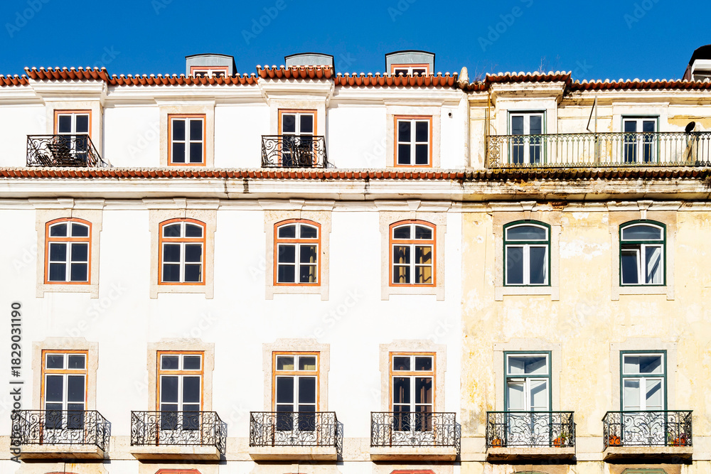 Obraz premium Typical old buildings in Lisbon's lower town, with their windows with balconies, lanterns, and decorative tiles. Lisbon, Portugal, 2023