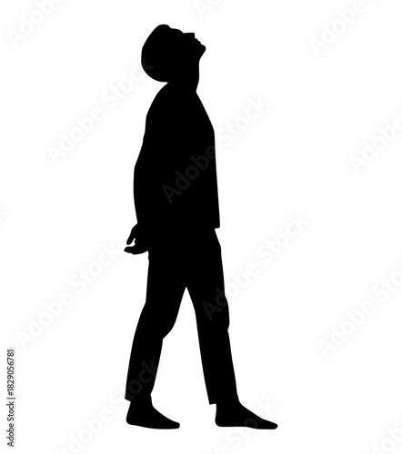 Silhouette of a man standing in profile looking up towards the sky in contemplation