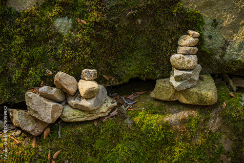 Stacked Prayer Stones on Mossy Rock Surface