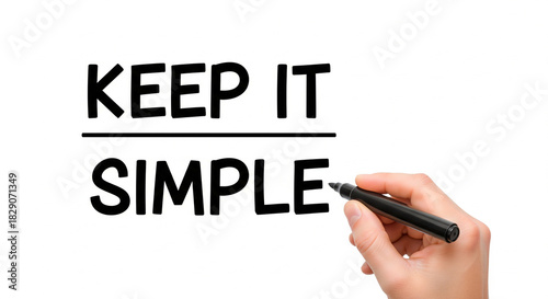 Hand writing 'Keep It Simple' on a white background with a black marker