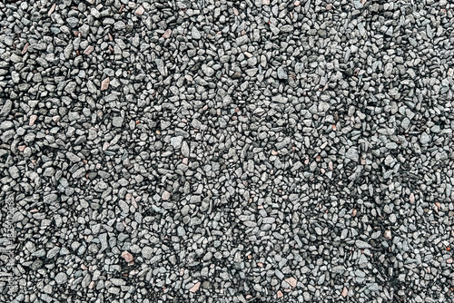 Gray gravel surface with small stones ideal for construction and landscaping projects