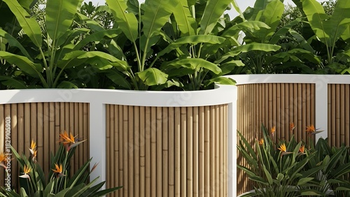 Modern curved bamboo fence design surrounded by lush tropical plants and colorful flowers in sunlight.  
