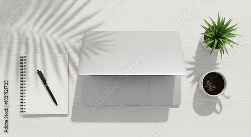 Top view of modern minimalist workspace with laptop and coffee cup on white desk, flat lay business concept with copy space.