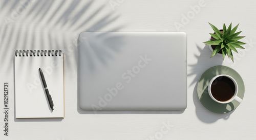 Top view of modern minimalist workspace with laptop and coffee cup on white desk, flat lay business concept with copy space.