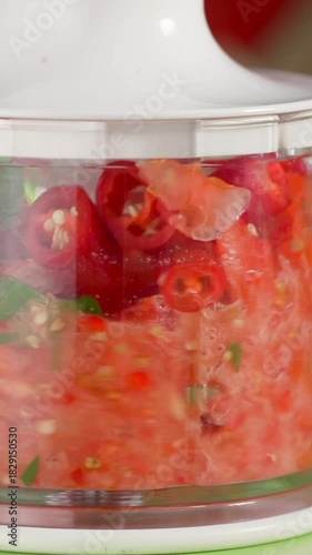 Chopping fresh tomatoes and herbs for a delicious salsa in a bright kitchen