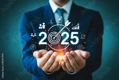 Businessman holding vision for 2025 with business growth and success icons, financial planning and investment strategy concept