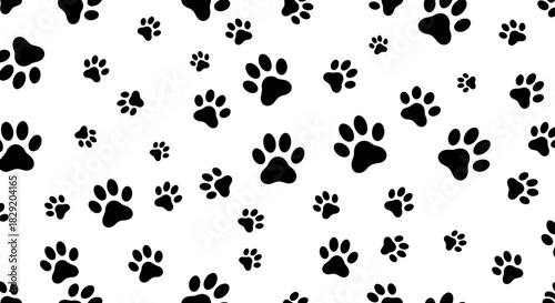 A dynamic and engaging seamless vector pattern showcases multiple black animal paw prints of varying sizes scattered across a bright white backdrop.