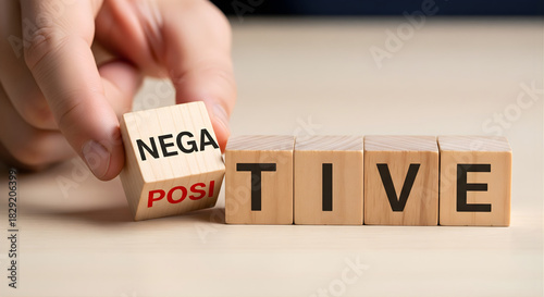 Choosing positive attitude overcoming negativity hand flipping wooden cube with words positive and negative representing optimism resilience mental strength mindset success