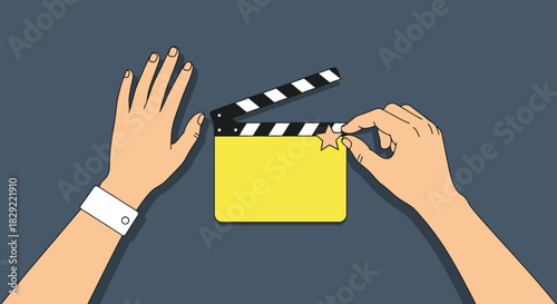 Two hands are shown holding a yellow and black movie clapperboard against a gray background, ready to start filming a scene