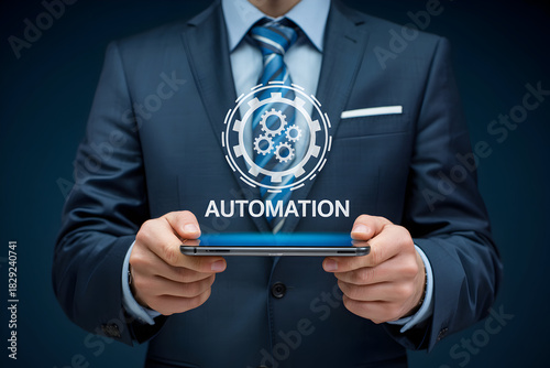 Businessman in a suit holds a smartphone displaying an automation graphic representing efficiency and technological advancement in business processes and solutions