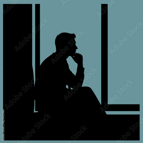 Silhouette of a man deep in thought by a window.