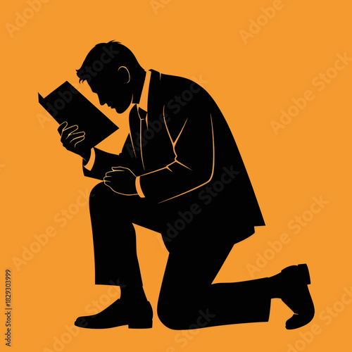 Man in silhouette kneeling and reading a book with intense focus.