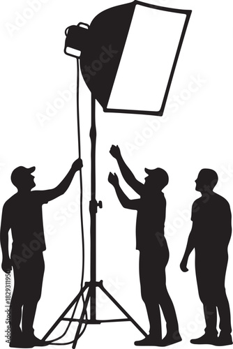 Three people setting up a studio softbox light, isolated on