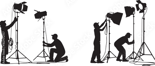 Photographers setting up studio lights for a photoshoot, isolated on