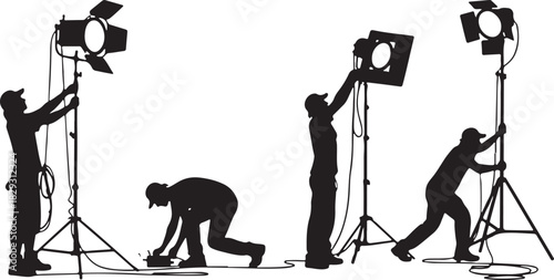 Film crew setting up studio lights for a production, isolated on