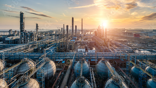 Oil refinery and chemical plant industrial area at beautiful sunset.