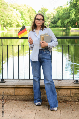 Young woman with flag of Ge...