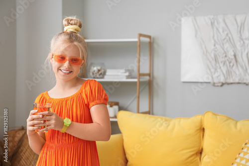 Little girl with glass of j...
