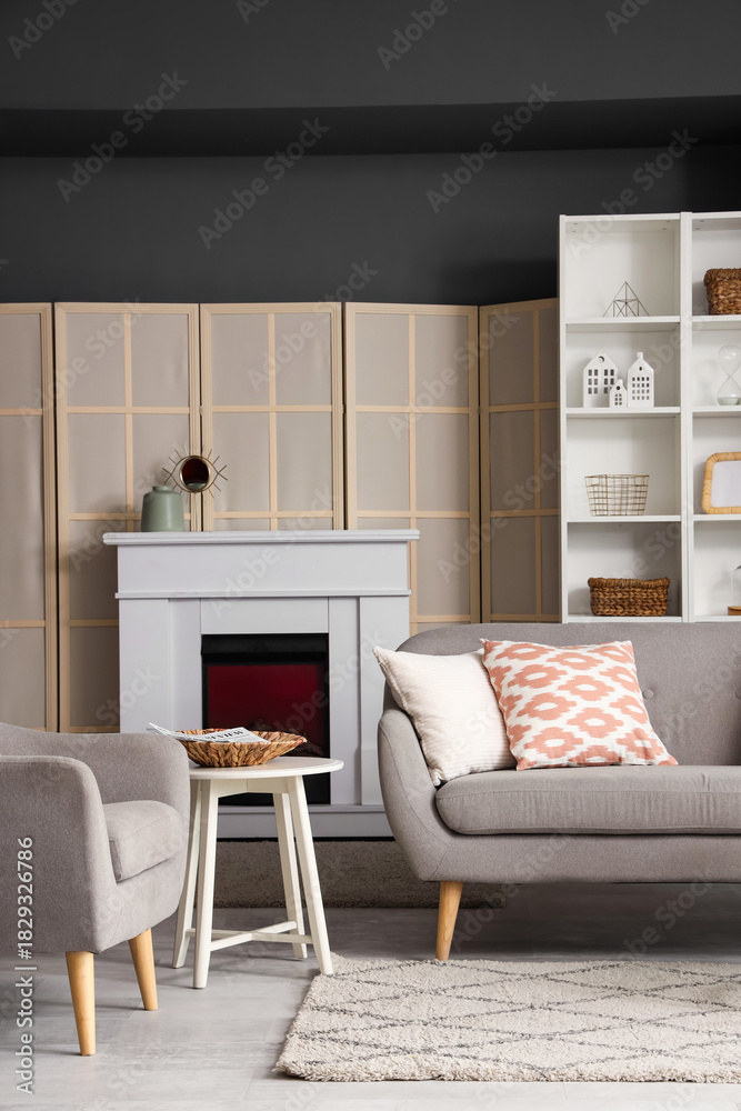 Naklejka premium Interior of living room with electric fireplace and sofa