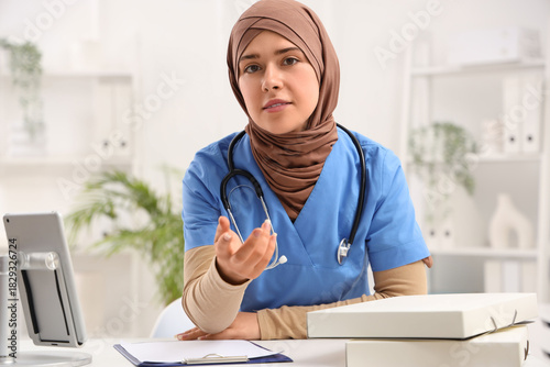 Female Muslim doctor in clinic
