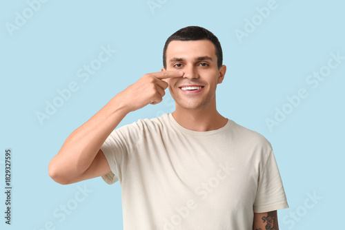 Ill young man pointing at n...